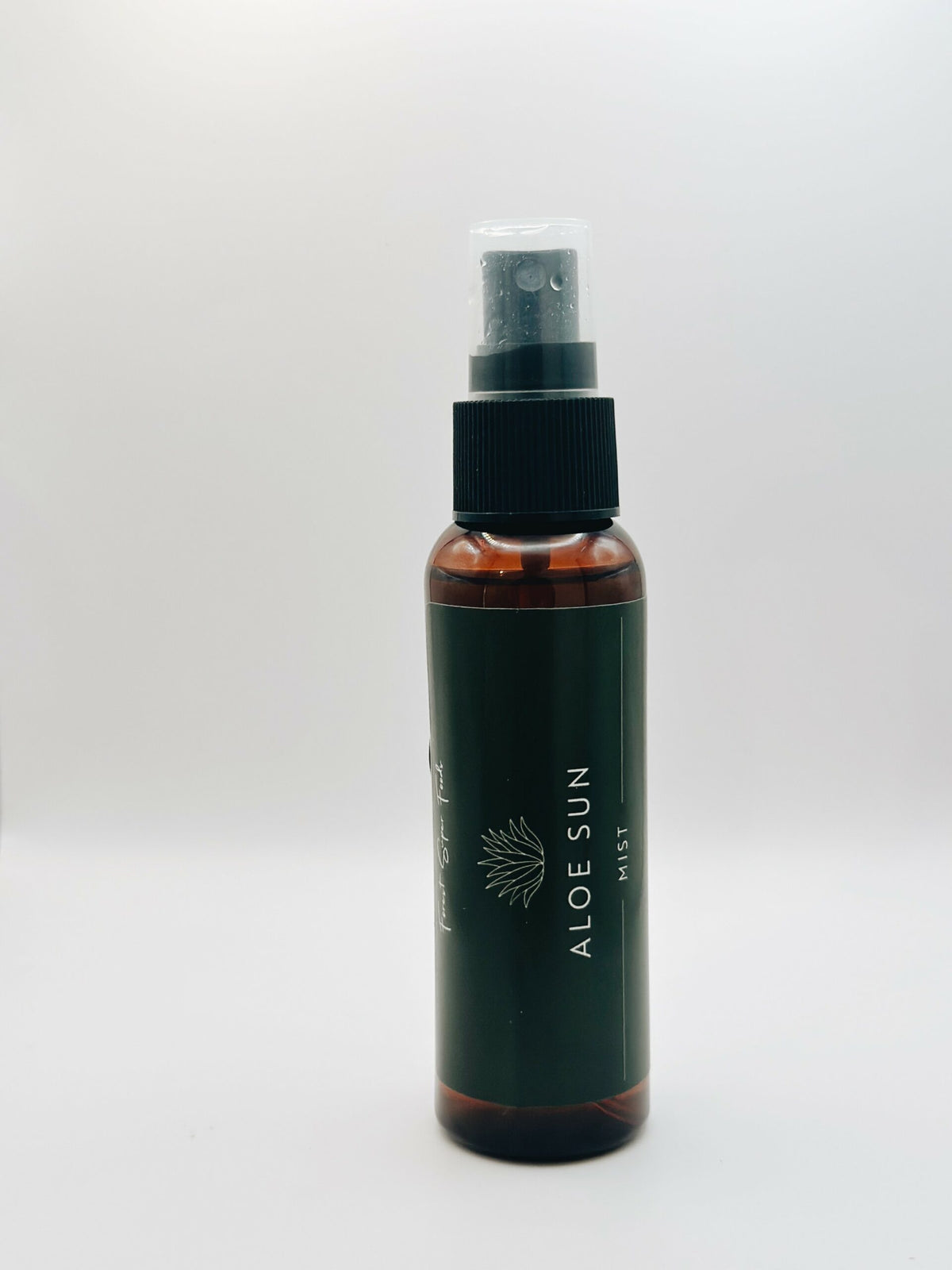 Aloe Mist spray bottle with dark label standing on white background for skin cooling and hydration by Forest Super Foods