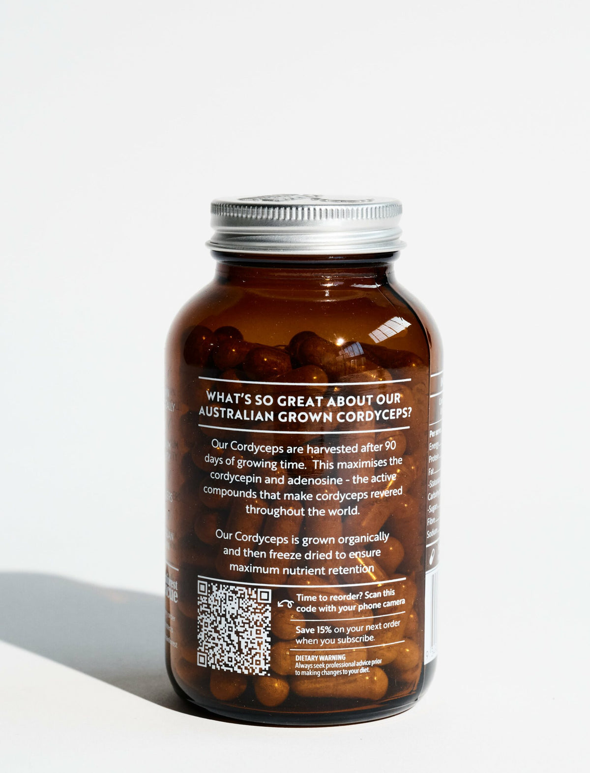 Amber glass jar showing text about Australian grown Cordyceps with QR code against white background